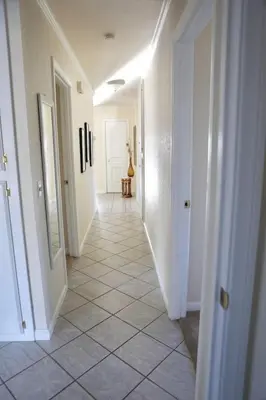 a hallway with white walls and a tile floor at Quiet Hilltop Home With Stunning Hill Top And Valley Views in Valley Center
