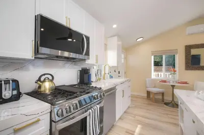 a kitchen with a stove and a microwave at Monarch Cove - Unit C For 4ppl in Oceanside