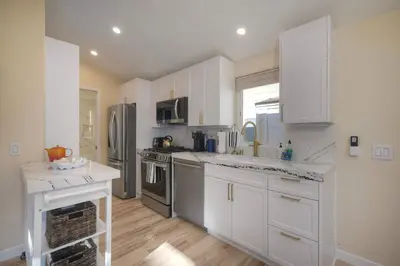 a kitchen with white cabinets and stainless steel appliances at Monarch Cove - Unit C For 4ppl in Oceanside