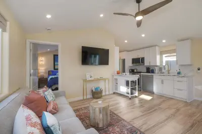 a living room with a couch and a kitchen at Monarch Cove - Unit C For 4ppl in Oceanside