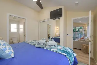 a bedroom with a blue bed with towels on it at Monarch Cove - Unit C For 4ppl in Oceanside
