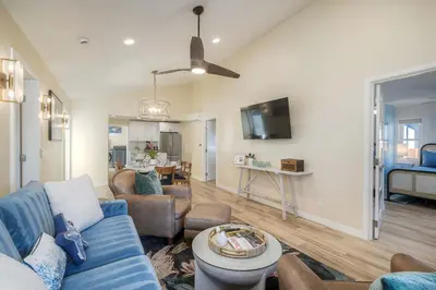a living room with a blue couch and a table at Monarch Cove - Unit A For 7ppl in Oceanside