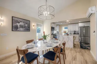 a dining room and kitchen with a table and chairs at Monarch Cove - Unit A For 7ppl in Oceanside