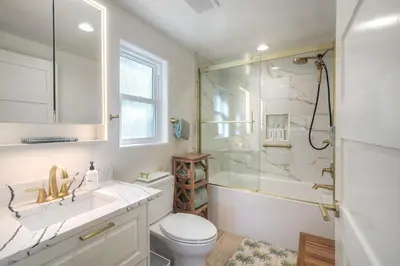 a bathroom with a shower and a toilet and a sink at Monarch Cove - Unit A For 7ppl in Oceanside