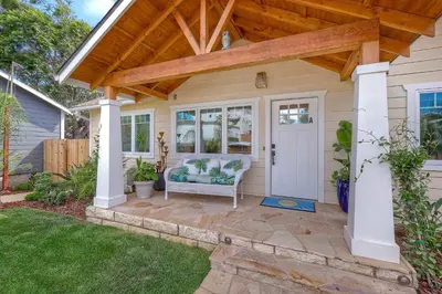 a pergola over a patio with a chair on a lawn at Monarch Cove - Unit A For 7ppl in Oceanside