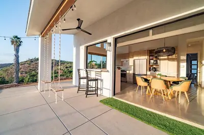 a kitchen and dining room with a table and chairs at Vista Oasis with Spa, Pool, & Views in Vista
