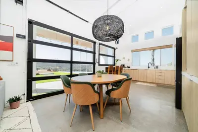 a kitchen and dining room with a table and chairs at Vista Oasis with Spa, Pool, & Views in Vista