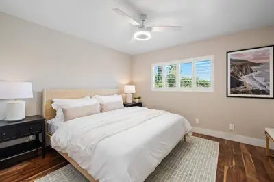 a bedroom with a large bed and a ceiling fan at Mt. Helix Resort+ Pool/Spa, Pickleball, Amenities! in La Mesa