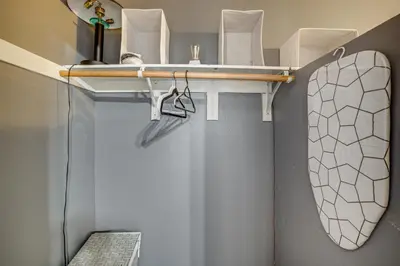 a bathroom with a toilet and a mirror on a shelf at Sip, Hike and Explore Quiet SoCal Studio with Patio! in Winchester