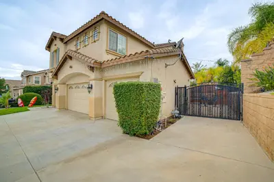 a house with a gate and a driveway at Sip, Hike and Explore Quiet SoCal Studio with Patio! in Winchester