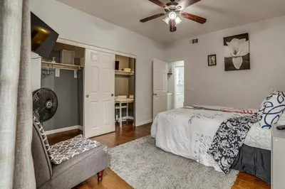 a bedroom with a bed and a chair and a fan at Sip, Hike and Explore Quiet SoCal Studio with Patio! in Winchester