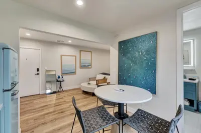 a kitchen and living room with a table and chairs at ON Avenida Del Mar Heart of Downtown 10 minute WALK to the Pier Parking in San Clemente
