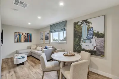 a living room with a couch and a table at ON Avenida Del Mar Heart of Downtown 10 minute WALK to the Pier Parking in San Clemente