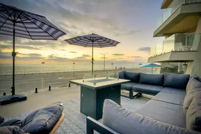 a living room with a view of the beach at Modern Ocean-View Retreat w/ Firepit & Steps to Carlsbad Beach in Carlsbad