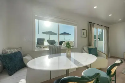 a living room with a white table and chairs at Modern Ocean-View Retreat w/ Firepit & Steps to Carlsbad Beach in Carlsbad
