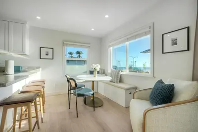 a kitchen and a living room with a table and a couch at Sycamore Haus Estate – Rent All 3 Ocean-View Luxury Condos Steps from Carlsbad State Beach in Carlsbad