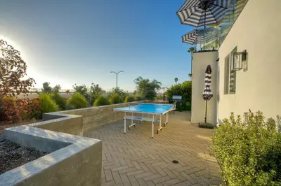 a ping pong table in the backyard of a house at Sycamore Haus Estate – Rent All 3 Ocean-View Luxury Condos Steps from Carlsbad State Beach in Carlsbad