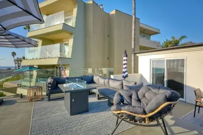 a patio with couches and a table and chairs at Sycamore Haus Estate – Rent All 3 Ocean-View Luxury Condos Steps from Carlsbad State Beach in Carlsbad