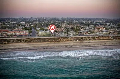 a stop sign on the beach near the ocean at Luxury Carlsbad Retreat | Across The Street From Beach | Firepit, BBQ, Ping Pong, Cornhole & More in Carlsbad