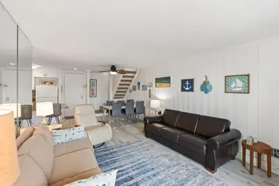 a living room with a couch and a dining room at Stunning Oceanview Penthouse | 2BR, Sleeps 6 | North Coast Village Resort in Oceanside