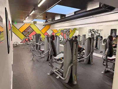 a gym with rows of tread machines in a room at Stunning Oceanview Penthouse | 2BR, Sleeps 6 | North Coast Village Resort in Oceanside