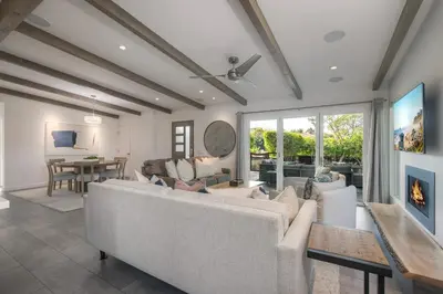 a living room with a couch and a table at Luxury 3-Bed Beach Cottage with Hot Tub, Fire Pit, BBQ - Walk To Beach in Cardiff-by-the-Sea