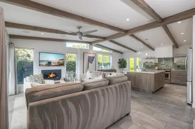 a living room with a couch and a fireplace at Luxury 3-Bed Beach Cottage with Hot Tub, Fire Pit, BBQ - Walk To Beach in Cardiff-by-the-Sea