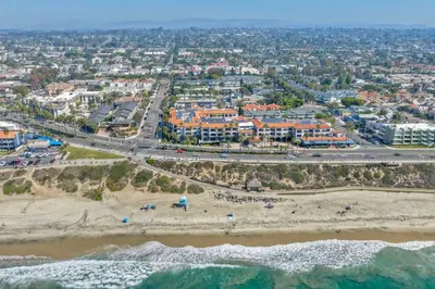 an aerial view of a beach and buildings at Coastal Cottage Steps from the Sand | Walk to Carlsbad Village, Dog-Friendly in Carlsbad