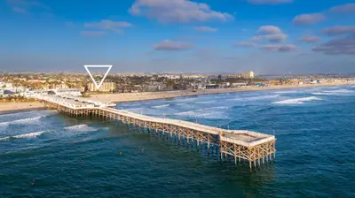 an aerial view of a pier on the beach at Pier View Sunset - Ocean Front, Patios, Location, Views in San Diego