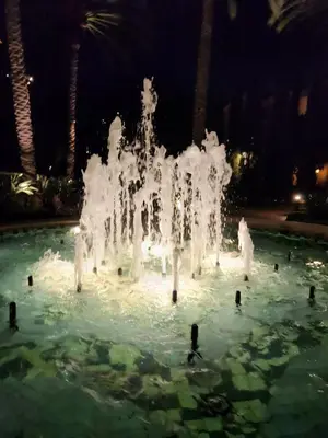a large ice fountain in the water at night at Irvine Spectrum 1 bed 1 bath in Irvine
