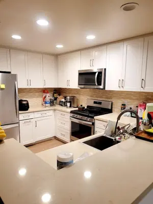 a kitchen with white cabinets and a stainless steel appliances at Irvine Spectrum 1 bed 1 bath in Irvine