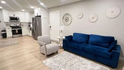a living room with a blue couch and a kitchen at 321 W Park El Cajon Back Unit by Sd stay in El Cajon