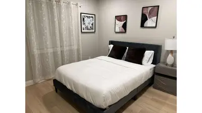a bedroom with a large bed with white sheets and pillows at 321 W Park El Cajon Back Unit by Sd stay in El Cajon