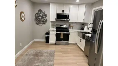 a kitchen with white cabinets and black appliances at 321 W Park El Cajon Back Unit by Sd stay in El Cajon