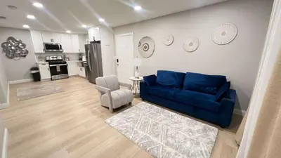 a living room with a blue couch and a kitchen at 321 W Park El Cajon Back Unit by Sd stay in El Cajon