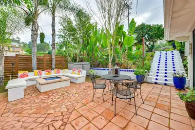 a patio with a table and chairs and a couch at Gather and Unwind Outdoors, Stylish Vista Retreat! in Vista