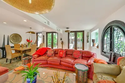 a living room with a red couch and a table at Gather and Unwind Outdoors, Stylish Vista Retreat! in Vista