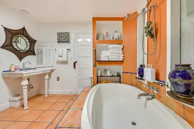 a bathroom with a bath tub and a sink at Gather and Unwind Outdoors, Stylish Vista Retreat! in Vista