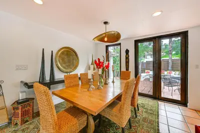 a dining room with a wooden table and chairs at Gather and Unwind Outdoors, Stylish Vista Retreat! in Vista