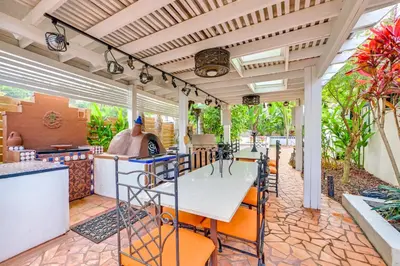 an outdoor kitchen with a table and chairs at Gather and Unwind Outdoors, Stylish Vista Retreat! in Vista