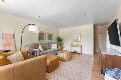 a living room with a couch and a tv at Light & Airy by Coastline Vacation Rentals in San Diego