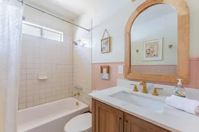 a bathroom with a sink and a tub and a toilet at Light & Airy by Coastline Vacation Rentals in San Diego