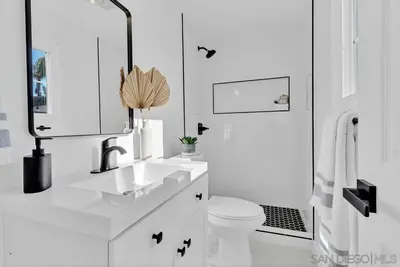 a white bathroom with a sink and a toilet at Poolside Paradise in Central SD in San Diego