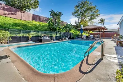 a swimming pool with a slide in a yard at Poolside Paradise in Central SD in San Diego