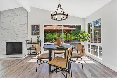 a dining room with a table and chairs at Poolside Paradise in Central SD in San Diego