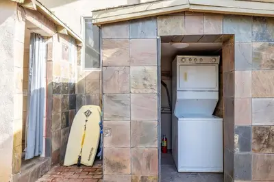 a house with a refrigerator and a stove in a garage at Vintage Beach Bungalow in Oceanside