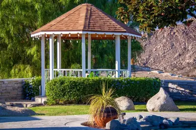 a girl in front of a gazebo in a park at Hilltop Wine Estate- Pickleball - Pool - 360 views in Temecula