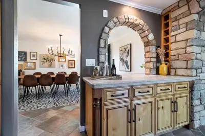 a kitchen with an archway and a dining room at Hilltop Wine Estate- Pickleball - Pool - 360 views in Temecula