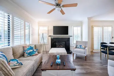 a living room with a couch and a fireplace at Luxe 2-Story Oasis with Private Pool & Backyard in Laguna Niguel