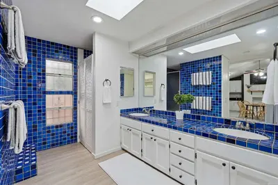 a blue tiled bathroom with two sinks and a large mirror at 4BR Family Retreat with Hot Tub Games & Fire Pit in Chula Vista